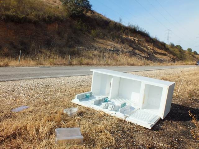 A freezer dumped on the side of the road near a tourist attraction